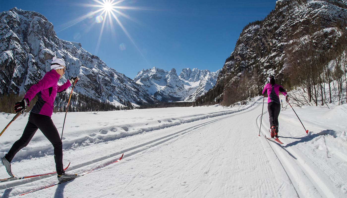 Two girls on a cross-country ski run in Val Pusteria in winter