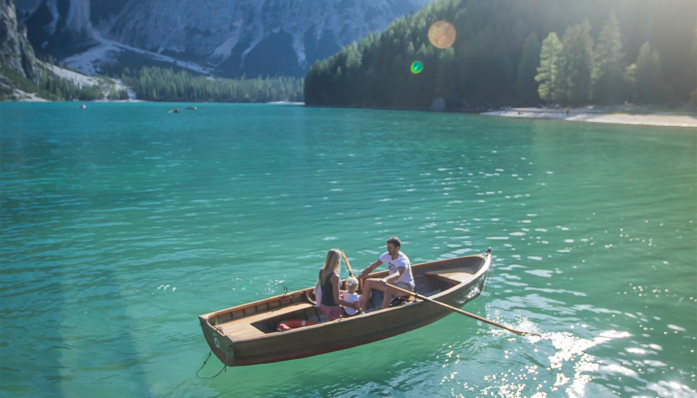 Una famiglia si gode una gita in barca sul lago di Braies in Val Pusteria in estate